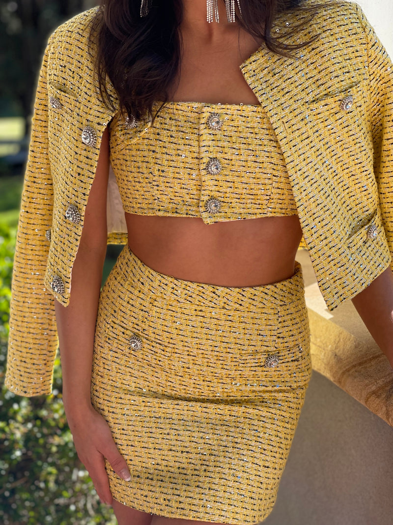 Yellow tweed bra, skirt and jacket set with jewel buttons